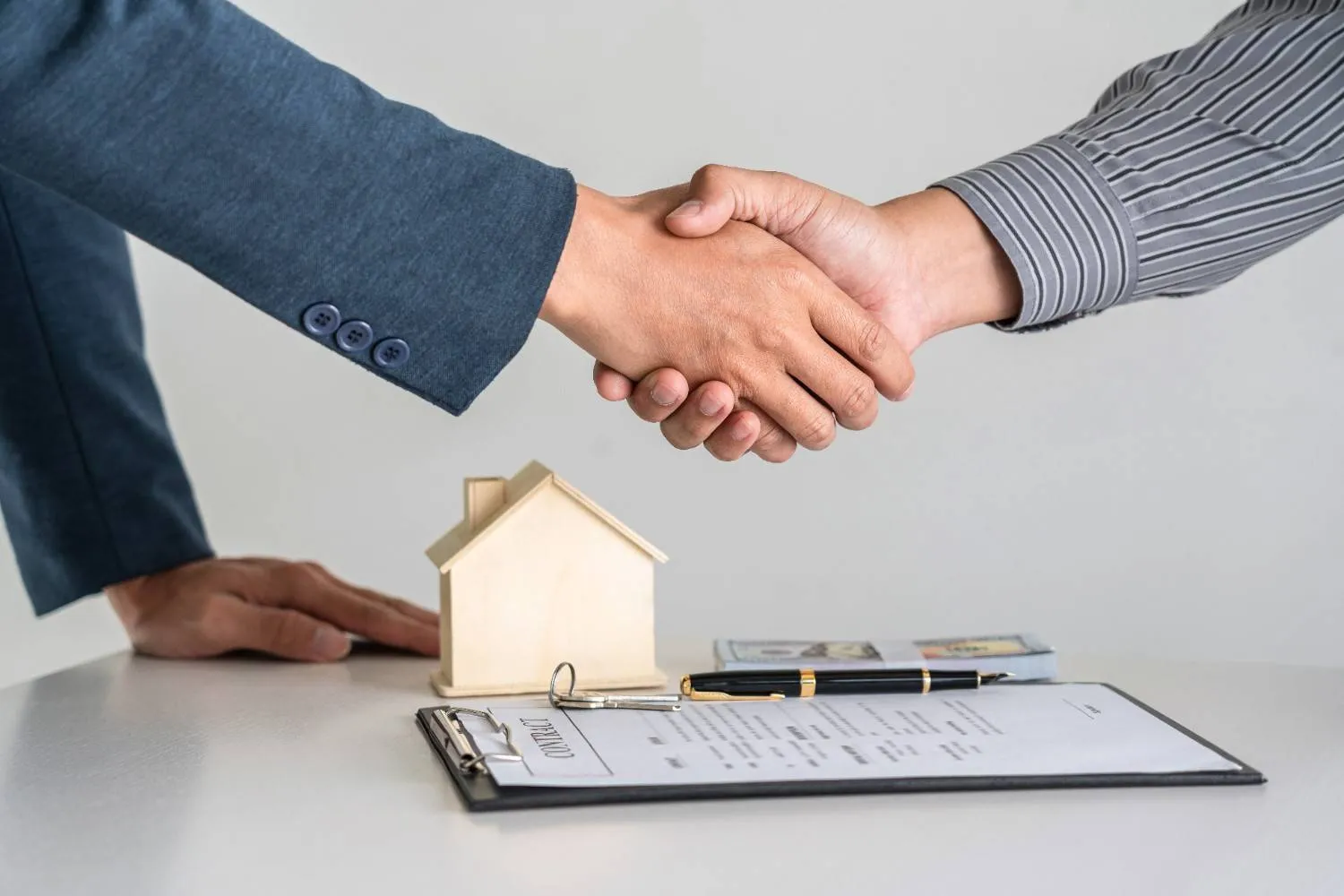 Homeowner reviewing a written cash offer at a kitchen table